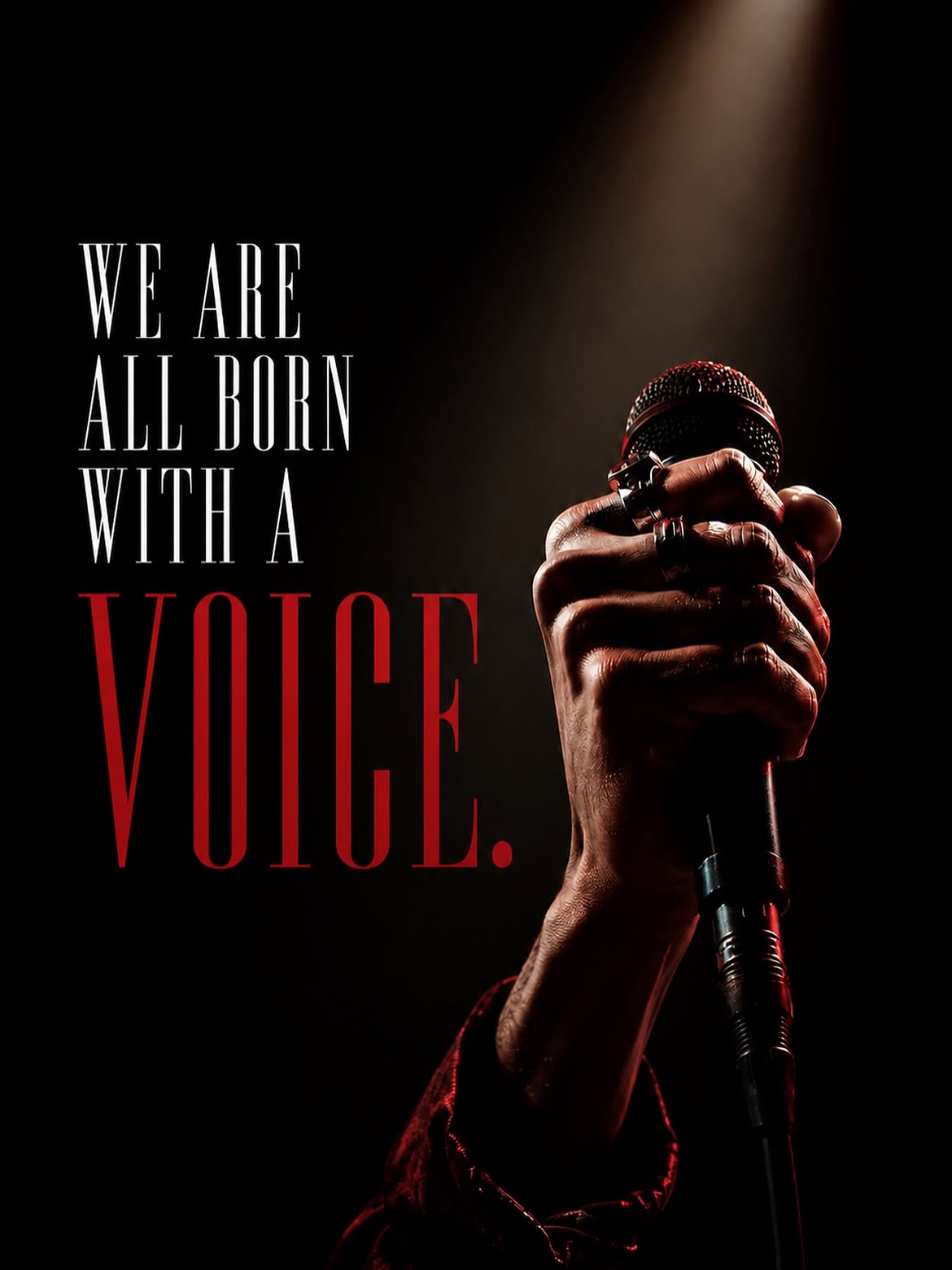 Hand holding a microphone under a spotlight